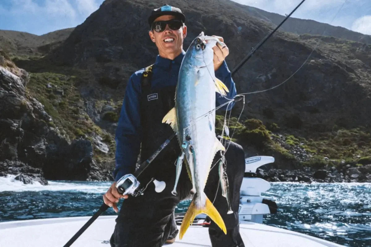 Angler holding yellowtail shown with a fully rigged Kicker Pk-rig