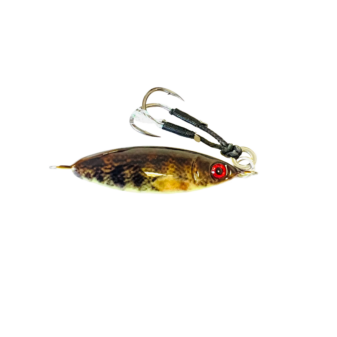 A fishing lure with a realistic brown and gold fish body, a red eye, and two treble hooks with black wrapped shanks, isolated on a white background.