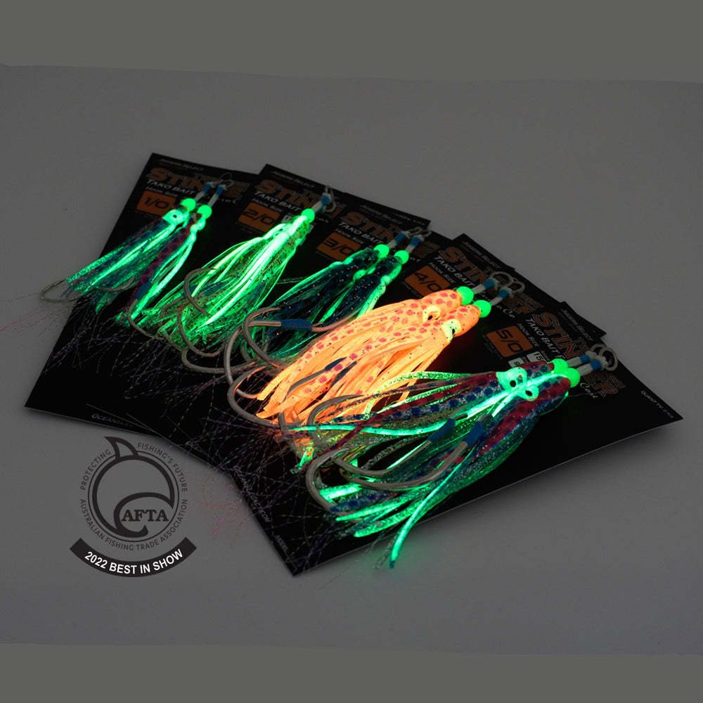 Glowing fishing lures on a black background with Ocean's Legacy logo.