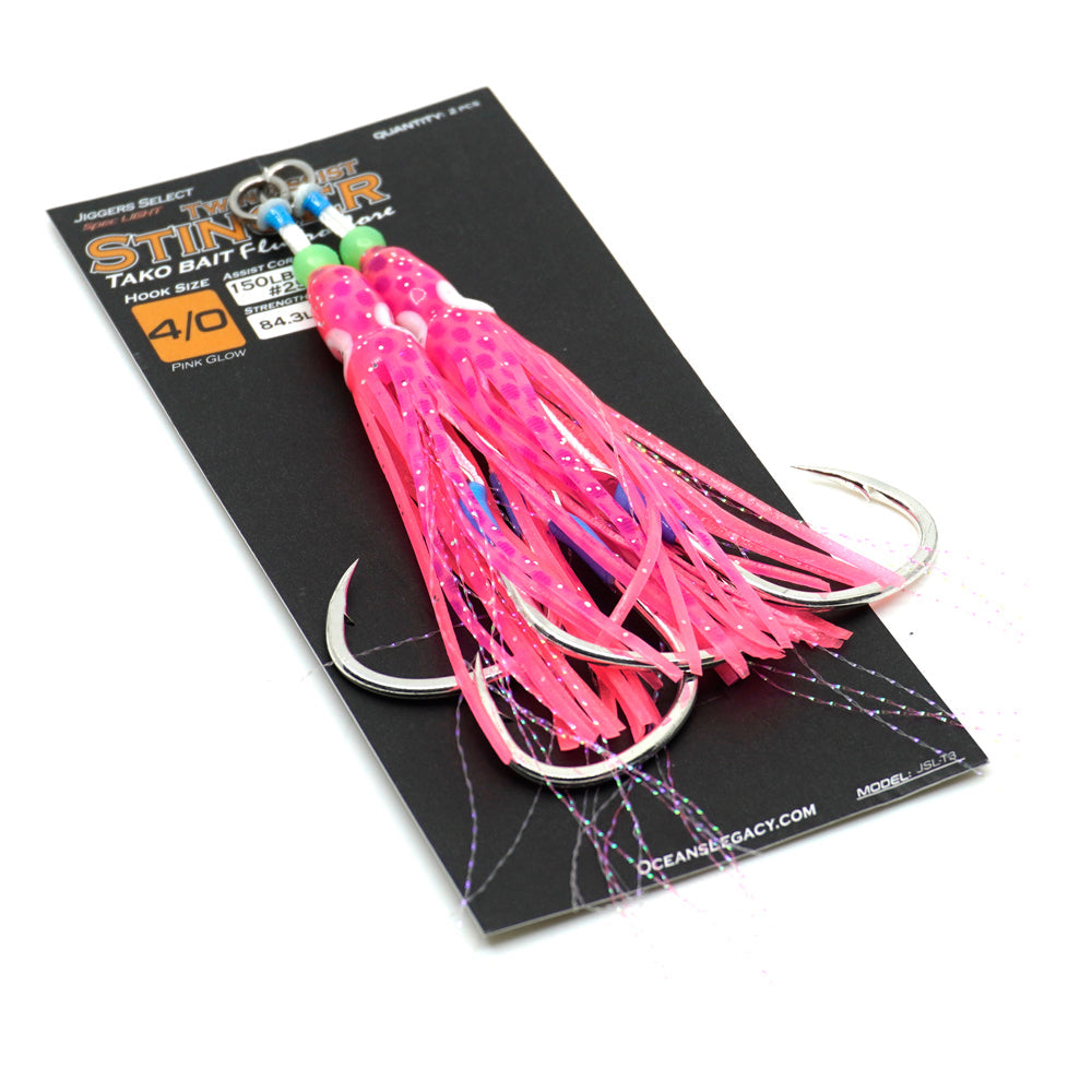 Pink fishing lure with treble hooks on a black card, featuring Oceangravity branding.