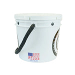 A white plastic bucket with a black rope handle, featuring a circular logo on the side and a small American flag graphic with red fishing lures near the bottom.