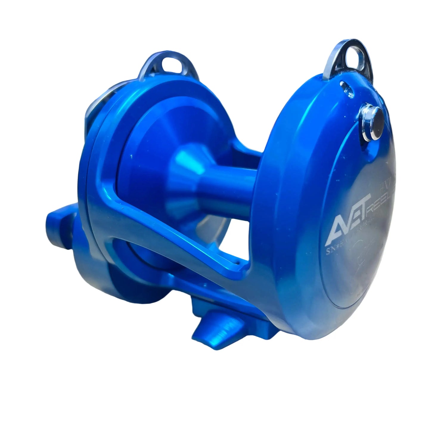 Blue fishing reel on a wooden surface with a blurred background