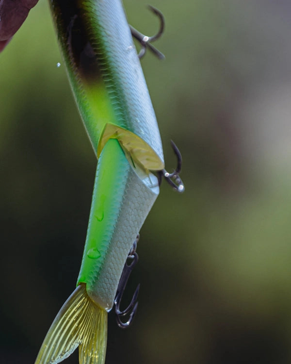 Close-up of a green and yellow fishing lure with a blurred background