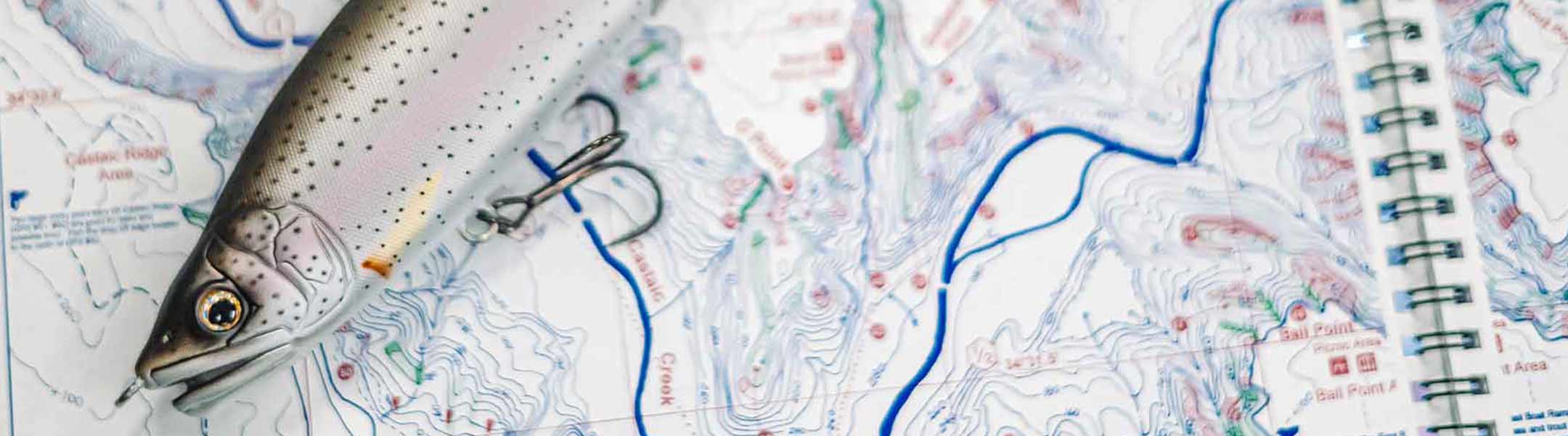 Image with fishing lure on top of a map.