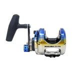 A Makaira 2011 Sea fishing reel with a black handle, featuring a metallic body with a blue-to-yellow gradient and silver accents, shown on a plain white background.