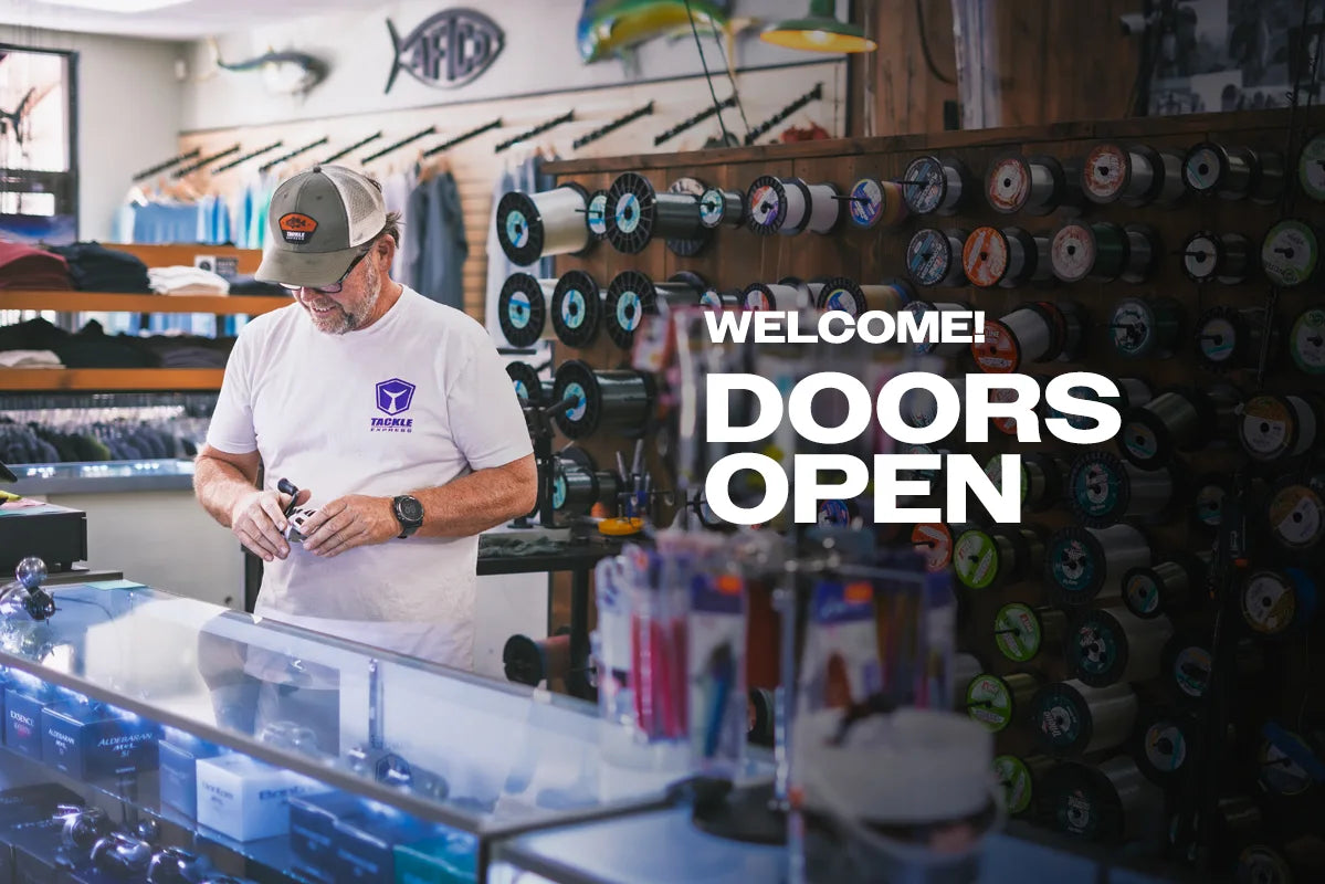 Man in a store with fishing equipment and 'Doors Open' text